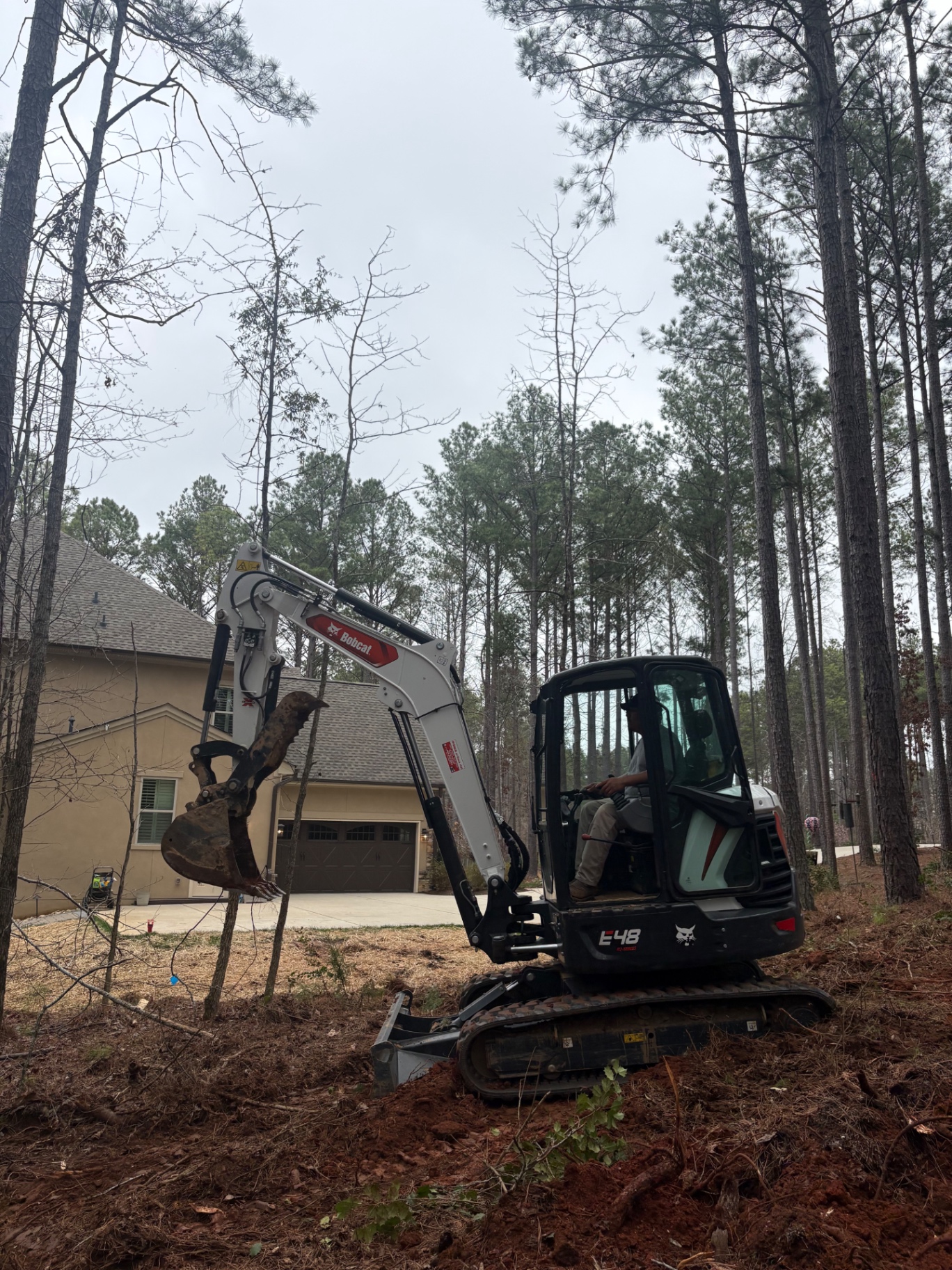 Excavator moving earth on a Charlotte, NC site preparation project
